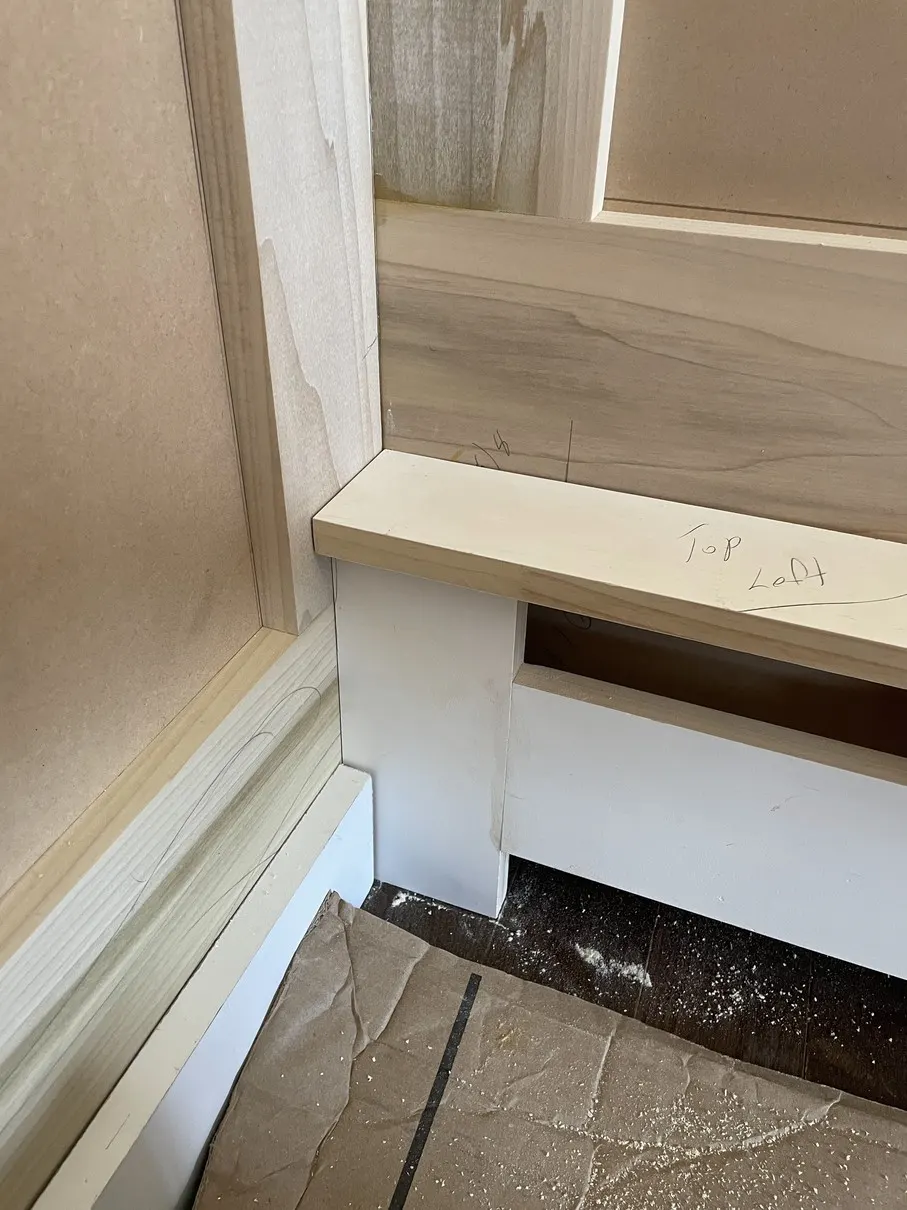 Stair skirt board and trim being fitted along a staircase by Old Town Renovations on Long Island